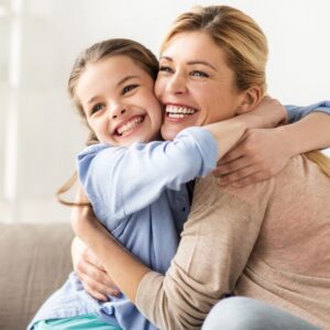 Single mum happy cuddling daughter after single mother therapy