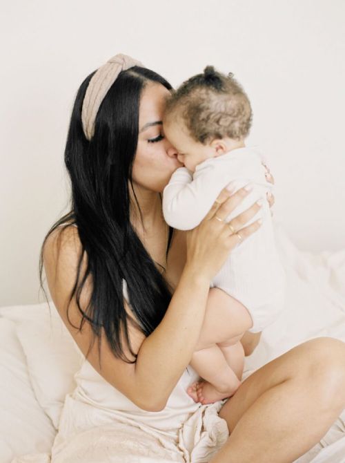 Mum kissing baby step