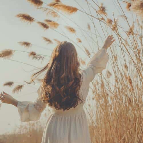 Woman walking through an abundant field