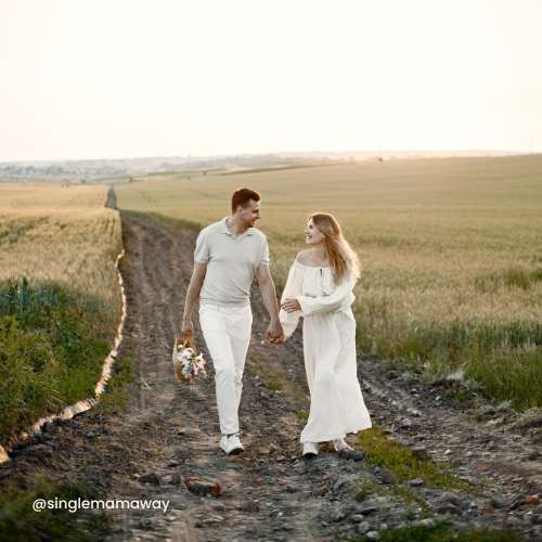 Woman & man walking together along a long dirt road