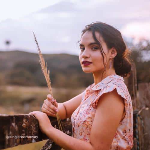 Woman standing at a boundary fence