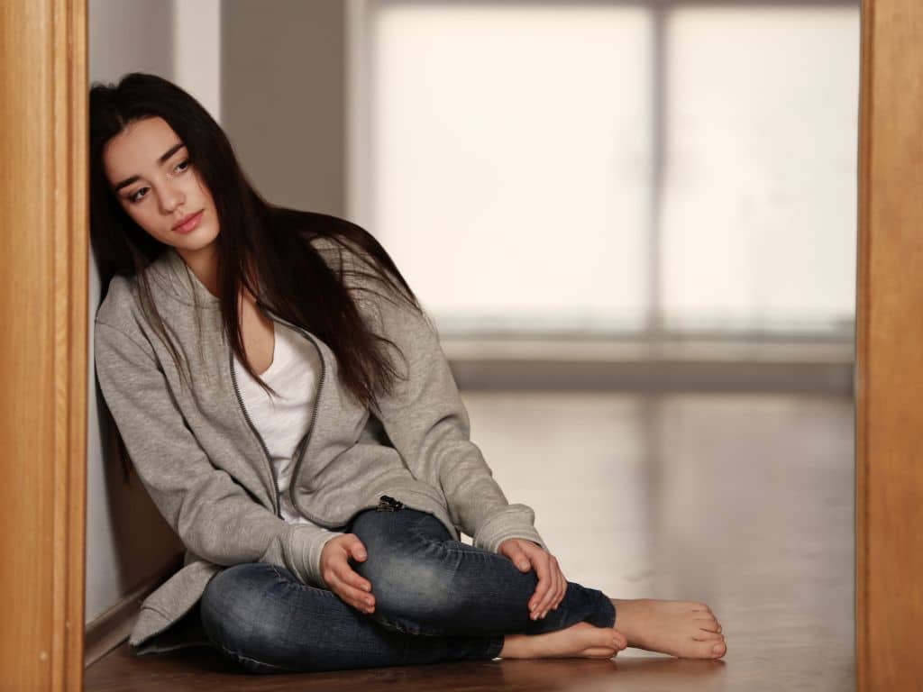 sad woman sitting on floor