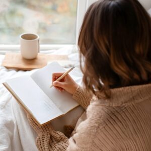 Divorce Recovery Program - Single Mama Way Counselling Single mum journalling with morning light, feeling calm and focused during divorce recovery.