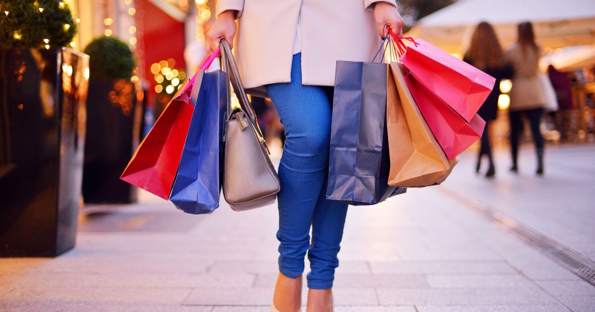 Woman carrying lots of bags after emotional spending
