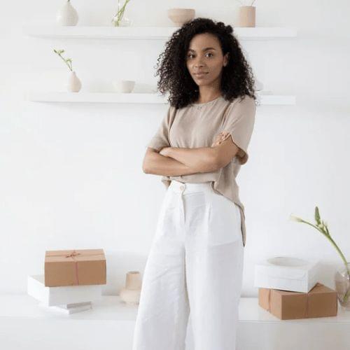 Woman standing with folded arms in a clean bright space