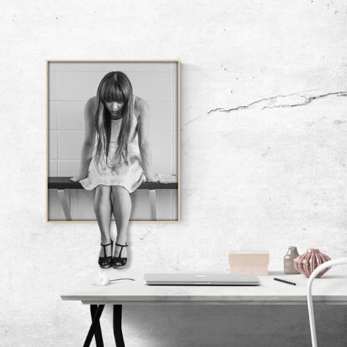 Woman climbing out of a picture onto a table