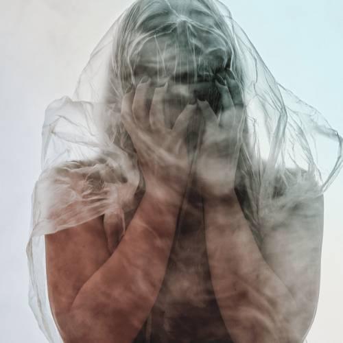 Woman covered by a vail of guilt